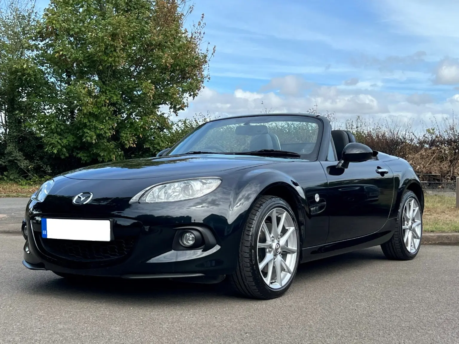 Black Mazda MX-5 photographed from the front three-quarter angle