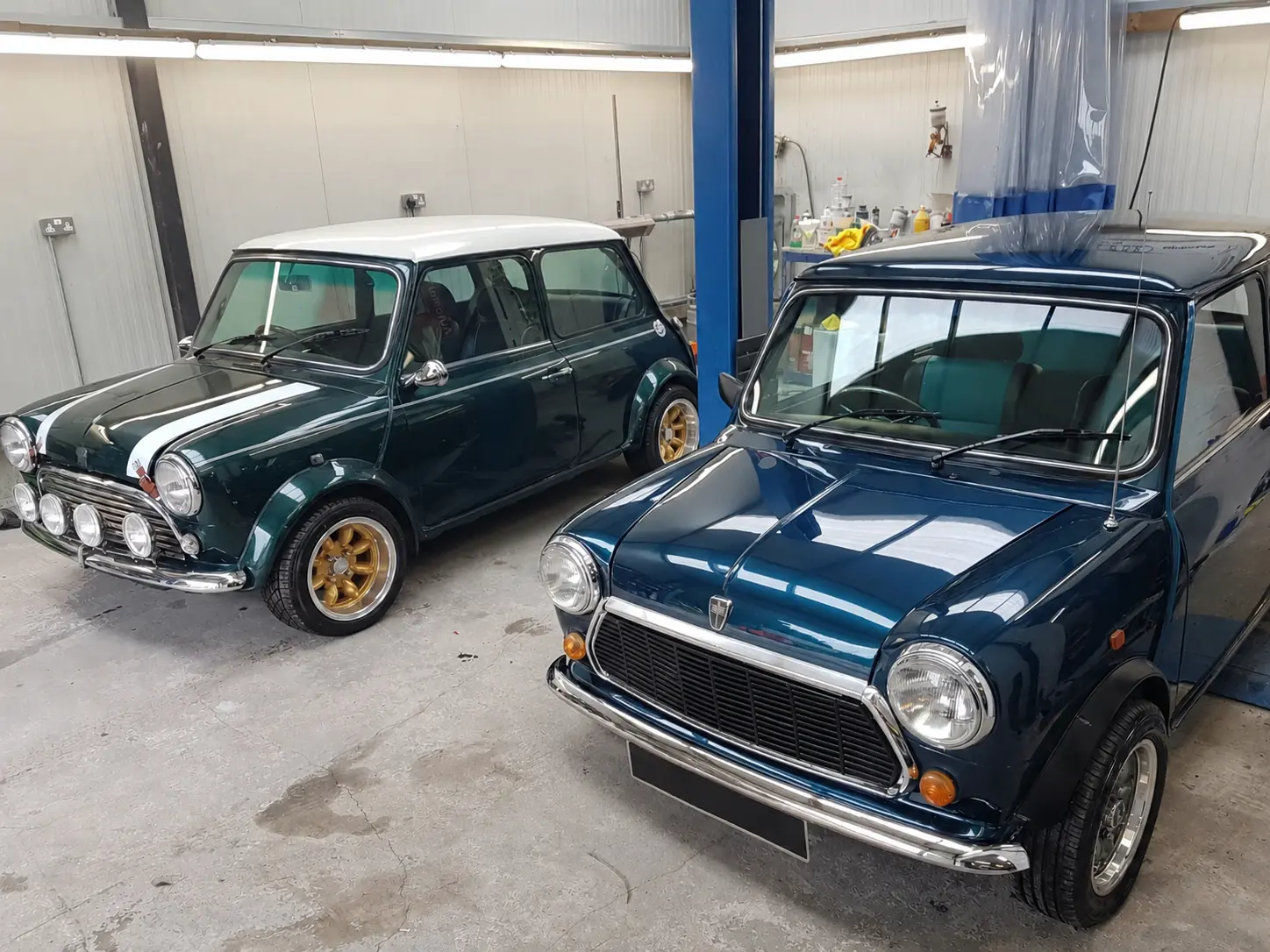 Two classic Minis in a clean vehicle workshop